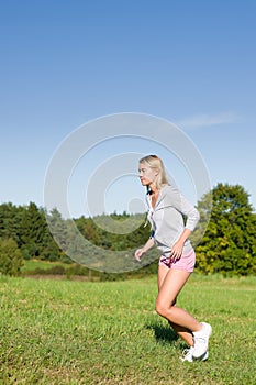 Jogging young sportive woman meadows sunny day