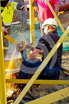 Tradesman working with an angle grinder on a building site