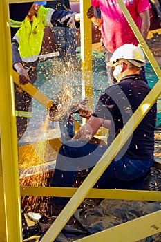 Tradesman working with an angle grinder on a building site