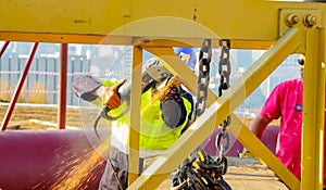 Tradesman working with an angle grinder on a building site