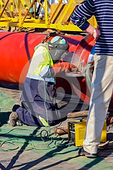 Tradesman working with welding torch