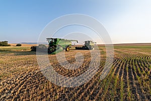 John Deere combines parked in a farm field in Idaho, USA - July 29, 2021