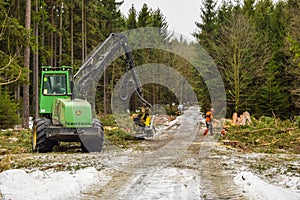 John deere harvester working in forest, wintertime