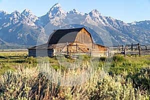 John Moulton Barn at Mormon Row in Grand Teton National Park on a clear, sunny morning in summer