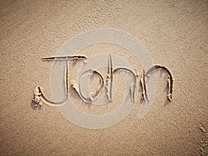 A John name written on the beach.