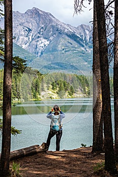 Johnson Lake Alberta Canada - Young Woman taking a picture with her phone