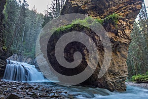 Johnston Canyon cave in Spring season with waterfalls, Johnston Canyon Trail, Alberta, Canada