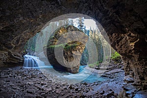 Johnston Canyon cave in Spring season with waterfalls, Johnston Canyon Trail, Alberta, Canada