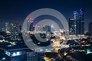 Johor Bahru, Malaysia, at night. Malaysian city with traffic on highway and modern business buildings and hotels in downtown.