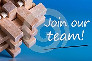 Join our team - message at blue background near macroviewed brain teaser. Hiring and new job concept