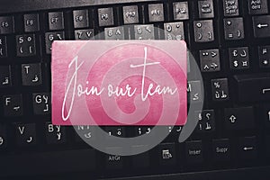 JOIN OUR TEAM, message on the card above arabic keyboard.