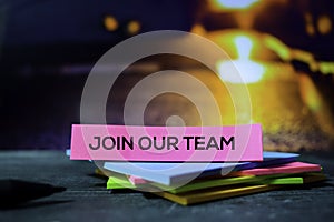 Join Our Team on the sticky notes with bokeh background