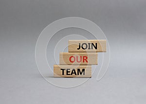 Join our team symbol. Wooden blocks with words Join our team. Beautiful grey background. Business and Join our team concept. Copy