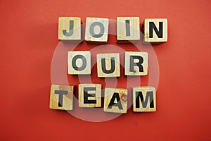 Join our team text alphabet letters on red background