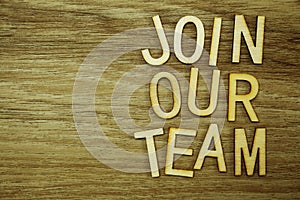 Join Our Team text message on wooden background