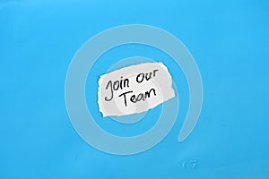 Join our team text on torn notepaper