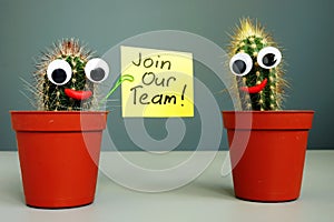 Join our team and two smiling cactuses. photo