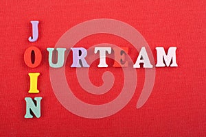 JOIN OUR TEAM word on red background composed from colorful abc alphabet block wooden letters, copy space for ad text. Learning