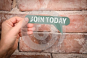 Join Today. Green speech bubble with text on a red brick background