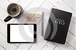 Join Us in Block Letters on a White Wooden Table with a Bible and Tablet