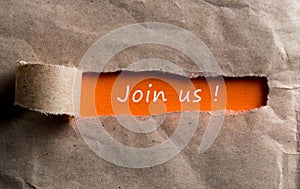 Join us - message appearing behind torn brown paper. Hiring and new job concept