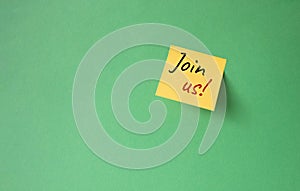 Join us symbol. Concept word Join us on orange steaky note. Beautiful green background. Business and Join us concept. Copy space