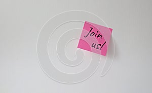 Join us symbol. Concept word Join us on pink steaky note. Beautiful white background. Business and Join us concept. Copy space