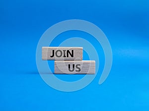 Join us symbol. Concept word Join us on wooden blocks. Beautiful blue background. Business and Join us concept. Copy space