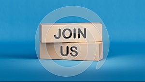 Join us symbol. Concept word Join us on wooden blocks.Businessman hand.