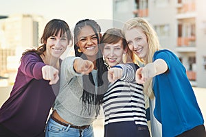 Join us today. Portrait of a group of women pointing their fingers at the camera together.