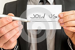 Join Us written on a business card