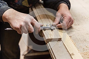 The joiner measures products. Joiner measuring tool at work