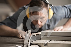 Joiner sawing wood photo