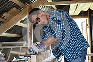 Joinery. The carpenter planes the wood in the workshop. Woodworking, roofing, diy.