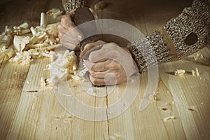 Joinery. Planing a natural wood furniture panel with a manual planer