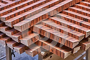 Joinery. Wood veneer wall panels elements are covered with dust. Rosewood reconstituted veneer. Furniture manufacturing