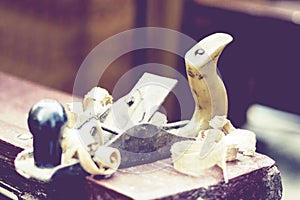 Joinery â€“ old wooden plane and chips in a workshop of the carpenter, retro concept