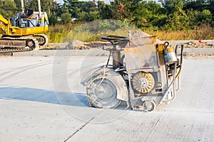 The joint cutter machine on a brushed concrete surface. Construction equipment for cutting saw slab