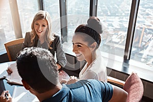 Joint decisions about joint finances. a young couple meeting with a financial planner in a modern office.