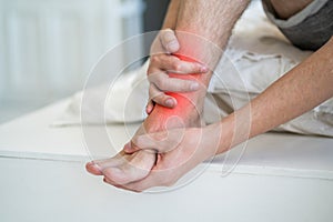 Joint inflammation, foot pain, man suffering from feet ache at home, podiatry concept