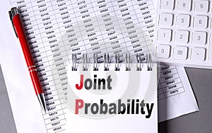 JOINT PROBABILITY text on notebook with chart , pen and calculator
