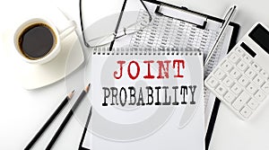 JOINT PROBABILITY text on the paper with calculator, notepad, coffee ,pen with graph