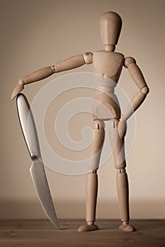 Jointed doll with a knife photo