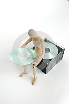 Jointed doll sitting cd stack photo