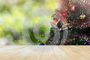 Jointed wood table top on lake and Xmas tree decoration on bokeh background with lens flare