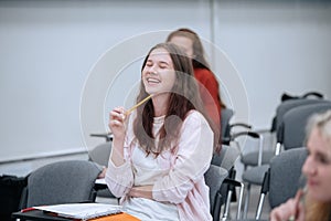 A joke from a physics professor made a student girl laugh very much, she laughs in class, sitting in the audience with