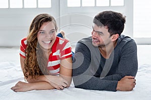 Joking caucasian love couple looking at camera in new apartment