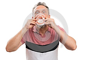 Joking man presenting close-up of fake denture as funny concept