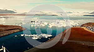 Jokullsarlon glacial lake in southwest Iceland. Aerial view of icebergs in the lagoon, going down from the sky