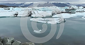 Jokulsarlon glacial lagoon lake in Iceland, chunks of blue icebergs, cold landscape in Europe.